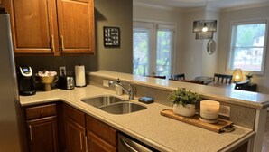 A kitchen with wooden cabinets, stainless steel appliances, and a granite countertop. - WALK to City Center! Elevator & 2 BDRMS just off Main St. (Helen)