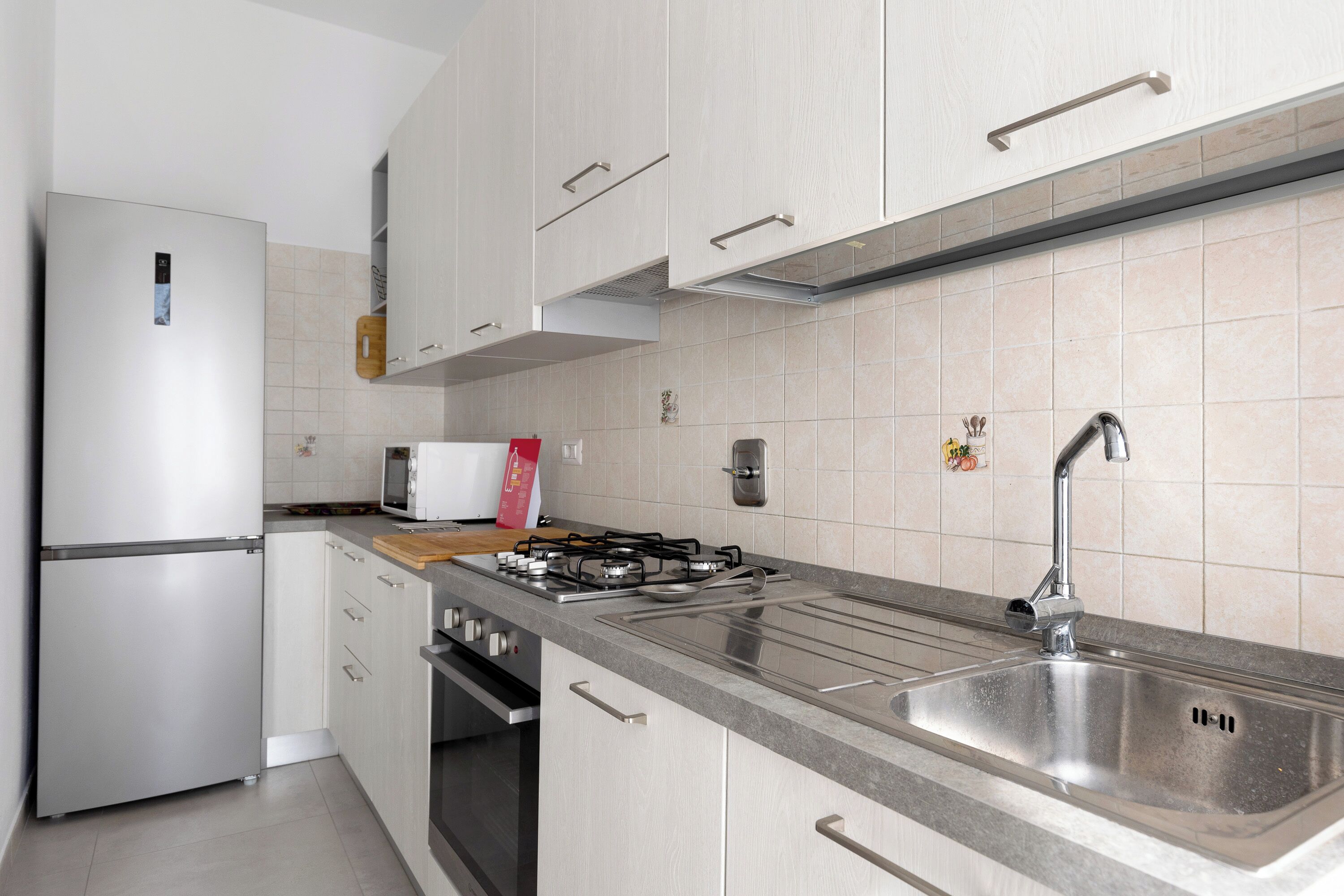 A modern kitchen with stainless steel appliances, a gas stove, and a sink.