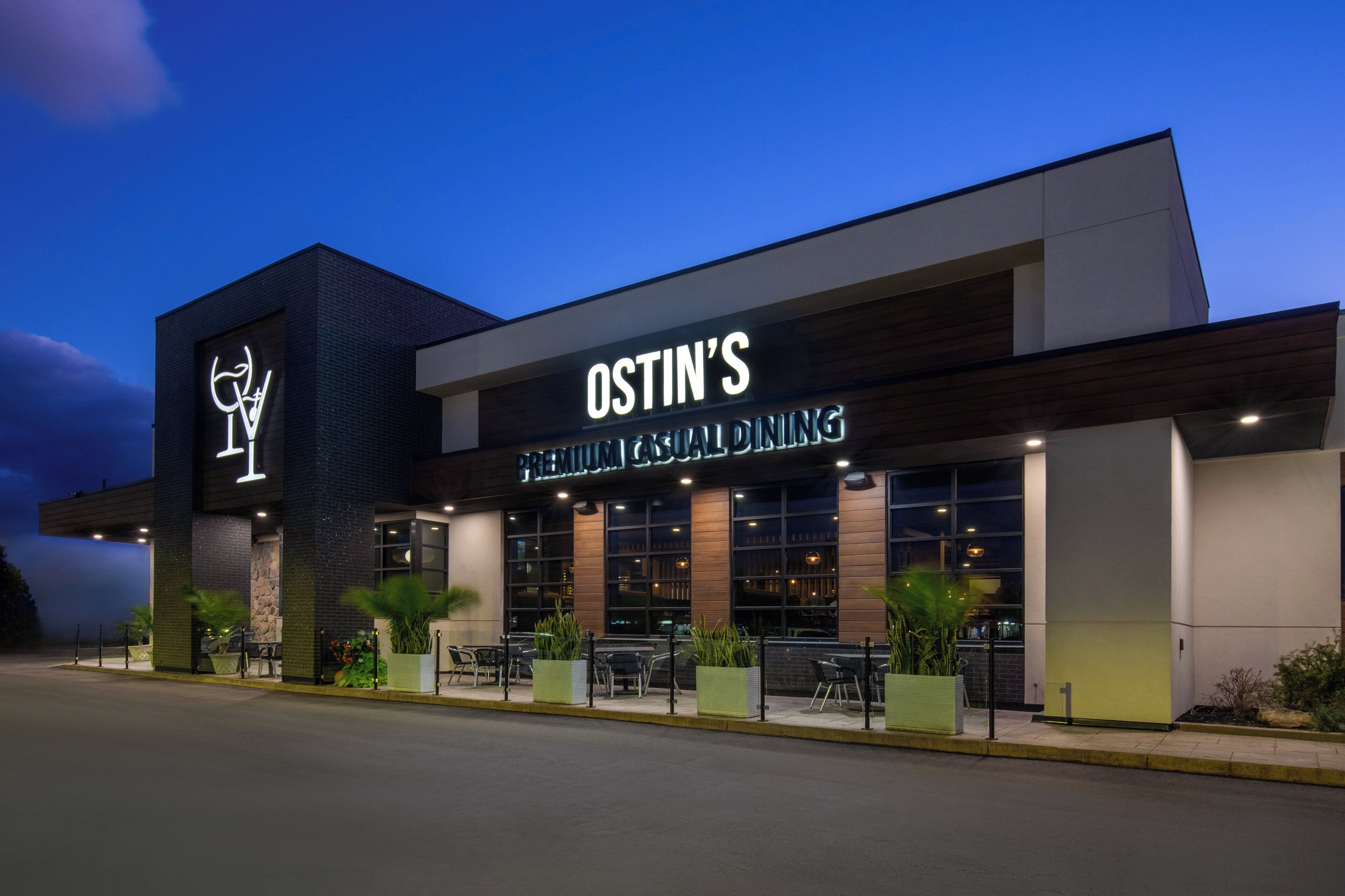 A modern building with a sign reading "OSTIN'S PREMIUM CASUAL DINING".