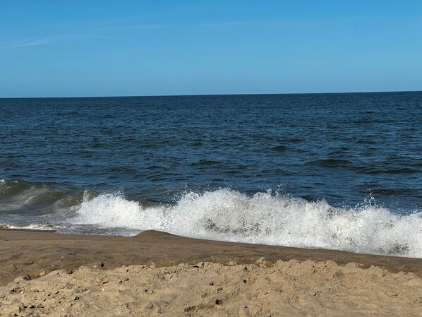 A beach with waves crashing onto the shore. -  Spacious ocean front 1 bedroom condo sleeps 6, located in mid town Ocean City (Ocean City)