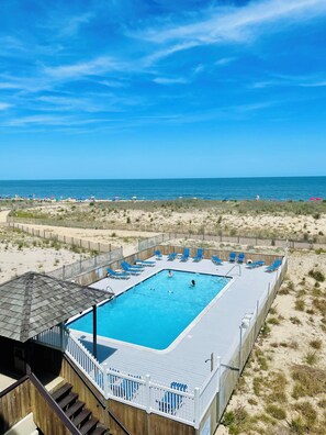 A pool area with a view of the beach and ocean. -  Spacious ocean front 1 bedroom condo sleeps 6, located in mid town Ocean City (Ocean City)