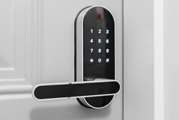 A modern door with a numeric keypad and a keyhole.