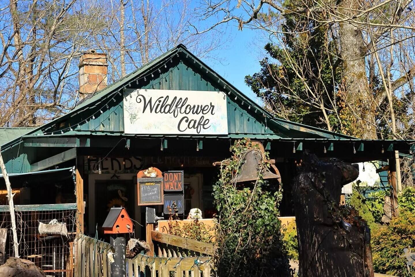 A rustic building with a sign reading "Wildflower Cafe".