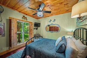 A bedroom with a bed, a ceiling fan, a window, and a mirror. - Paradise Found - Lookout Mt Edge, Hot Tub & Views (Mentone)