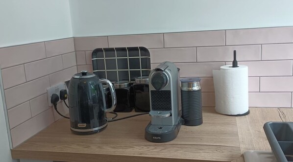 A kitchen counter with a coffee maker, a kettle, a Krups electric kettle, and a paper towel holder. - Perfect for discovering Westport, Mayo & Connemara (Westport)