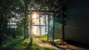 A pathway leading to a gazebo with a view of the water. - Luxe Lakefront: Spa, Kayaks, Pickleball, & Theater (Macon)