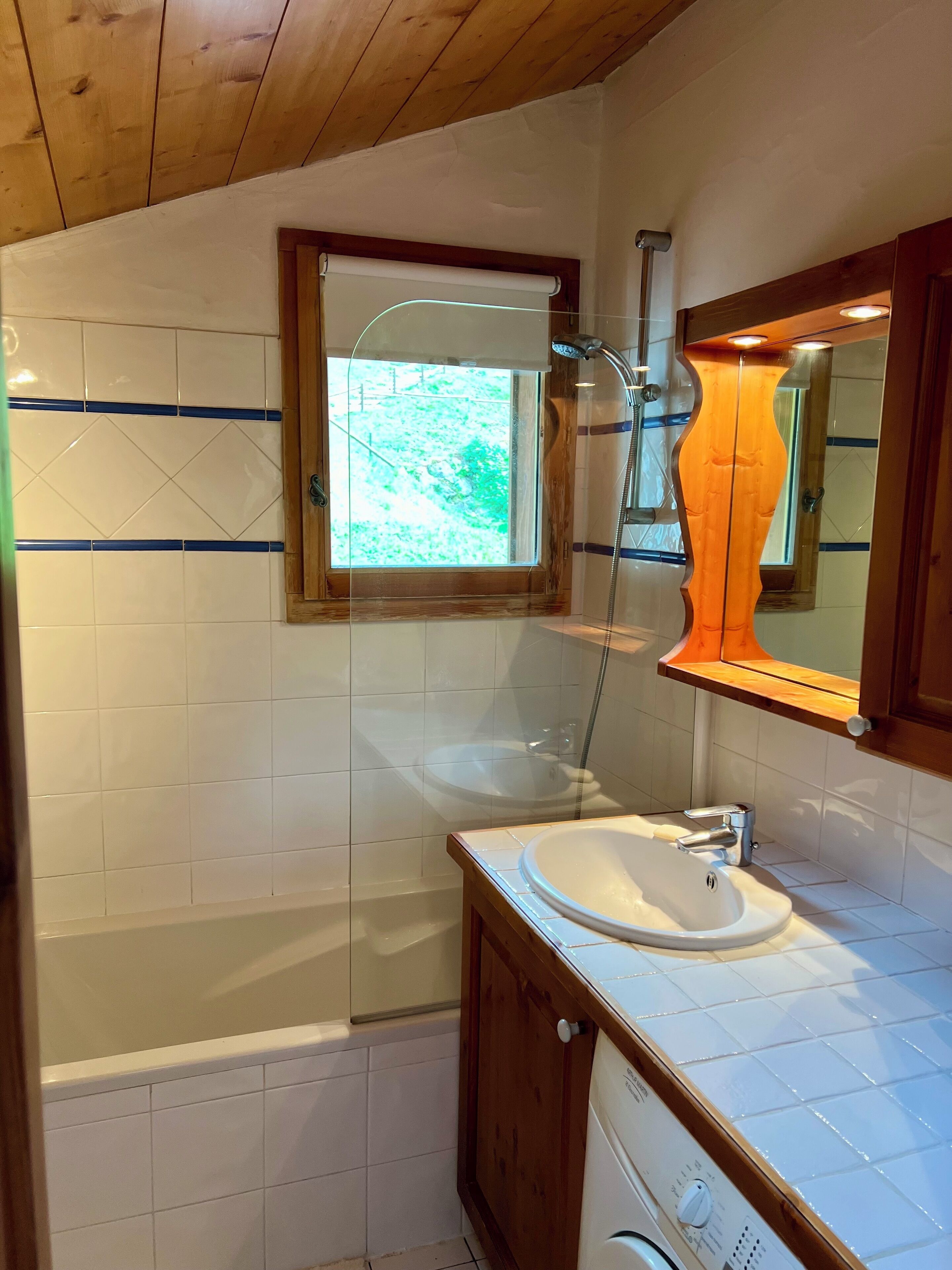 A bathroom with a bathtub, a sink, and a shower.