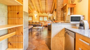 A kitchen with wooden cabinetry, a built-in microwave, and a dishwasher. - Holiday Home 'La Granja' with Mountain View, Wi-Fi and Air Conditioning (Olvan)