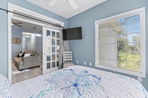 Relax in this spacious room with a large bed, a cozy seating area, and a flat-screen TV.