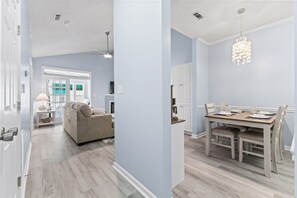 Enjoy a comfortable stay in this spacious room with a dining area, sofa, and window offering a view.