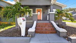 A residential house with a front porch, a mailbox, and a mailbox number 29.
