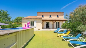A pool with inflatable toys, a covered patio, and lounge chairs. - Villa 'Cap Mer 17' with Private Pool, Private Terrace and Wi-Fi (Saint-Palais-sur-Mer)