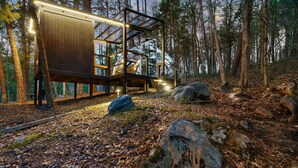 A modern wooden cabin with a glass extension, surrounded by a forest. - Mirrored Lost Lake Dome In Cosby - Your Ultimate Hideaway! (Cosby)