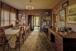 A room with a dining table, chairs, a wooden desk, and a bookshelf. - Welcome to A Scholarly Retreat, just a stroll from campus (South Bend)