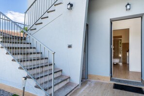 A staircase leading to a modern building with a visible bathroom interior.