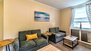 A cozy living area with two sofas, a coffee table, and a side table.