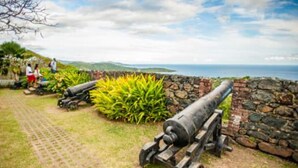 A historical site with cannons, a stone wall, and a paved pathway. -  Open concept space waiting to be discovered. 
Modern accessible & affordable.  (Buccoo)