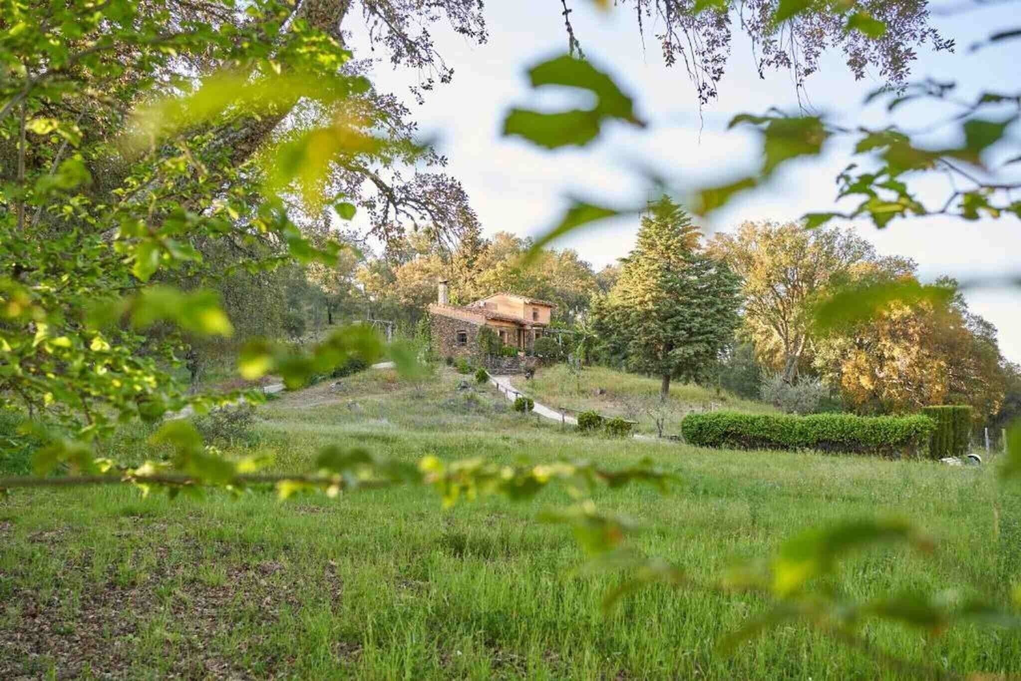 Una casa rodeada de un paisaje verde exuberante, con un camino que lleva a ella.