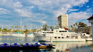 A marina with various boats docked, including a large yacht named 'Sea Trek'. - Quaint apartment with AC in lovely Oceanside (Oceanside)