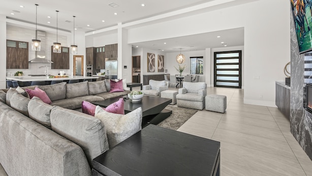 A spacious living area with a sectional sofa, a coffee table, and a fireplace. - Palm Villa- Luxury 8 Bed, Pickleball, Volleyball, Golf (Bermuda Dunes)