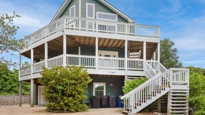 A two-story house with a balcony, a staircase, and a garage. - 2135 Pirates Perch * 11 Min Walk to Beach (Duck)