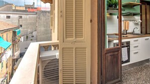 A kitchen with a window, a door, and a view of buildings.