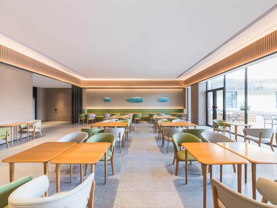 A modern dining area with tables and chairs arranged for seating.