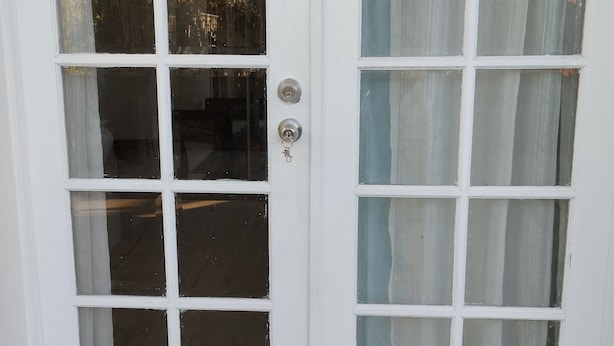 A white door with a keyhole and a lock. - Private guest suite @ Sorrento (Bundall)
