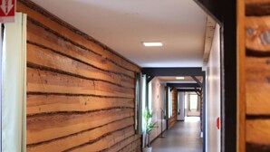 A hallway with wooden paneling and potted plants. - Every Room with a Beautiful View of The Wisconsin River * (Tomahawk)