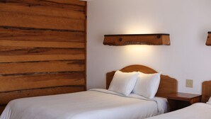 A room with two beds, wooden headboards, and a wall-mounted light fixture. - Every Room with a Beautiful View of The Wisconsin River * (Tomahawk)