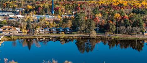 A lake with a water tower and houses in the background.