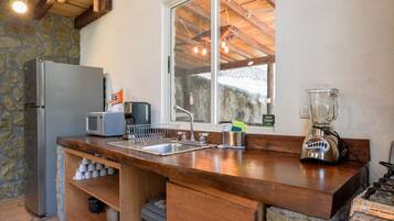Fridge, microwave, coffee/tea maker, cookware/dishes/utensils