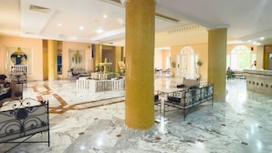 A spacious lobby with marble flooring, large columns, and a central seating area with a fountain. - Green Golf Hammamet (Hammamet)