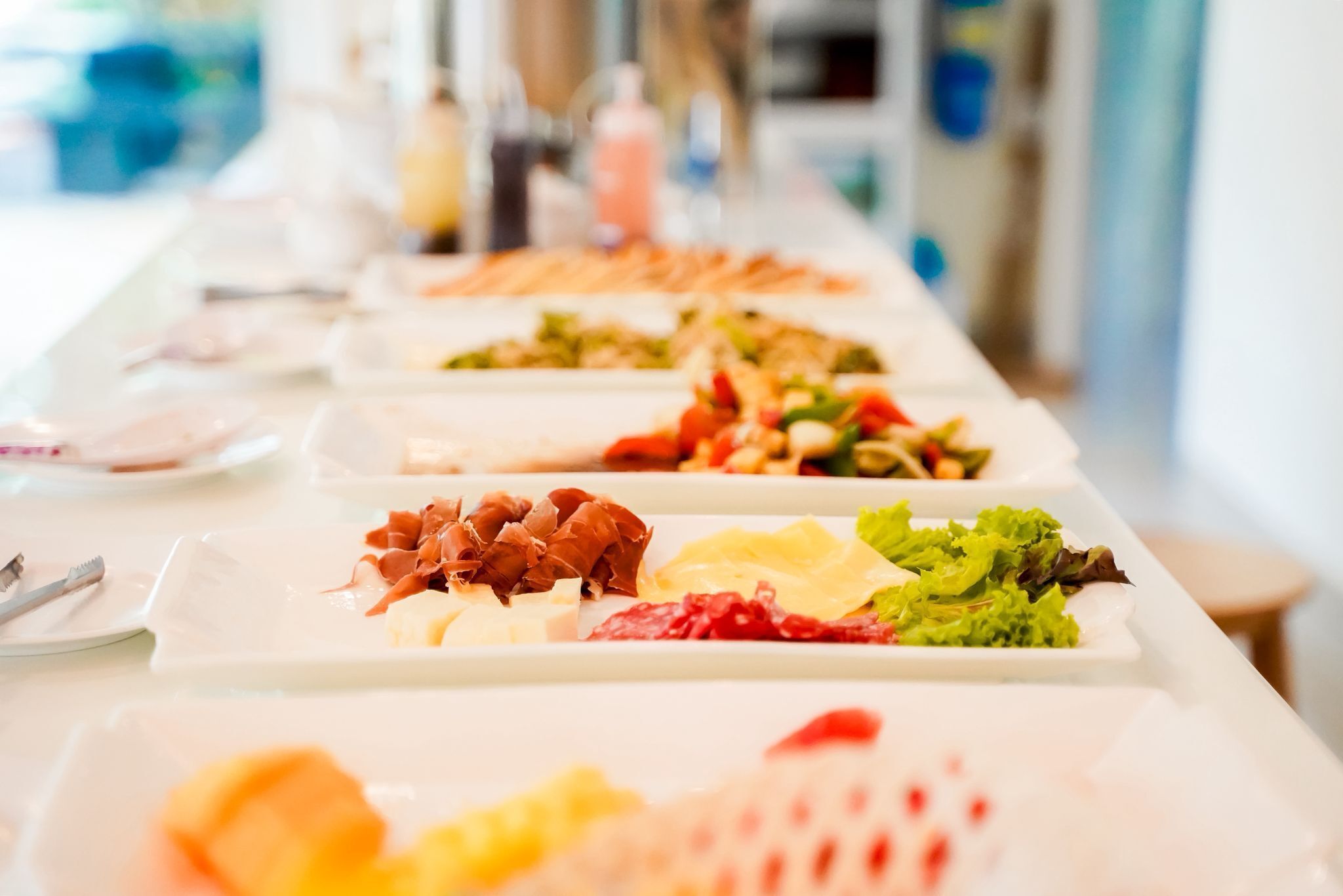 A buffet table with various food items.