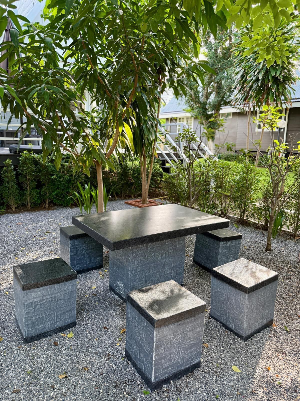 A stone table with benches in an outdoor setting.