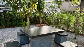 A stone table with benches in an outdoor setting.