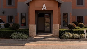 A modern building with a central entrance marked by a large 'A'.
