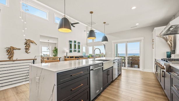 A spacious kitchen with a large island, modern appliances, and a view to the outside. - Four Seasons- Endless Ocean and Sound Views, Private Pool, and Hot Tub (Hatteras)