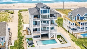A multi-story beachfront hotel with a swimming pool, balconies, and a beach view. - Four Seasons- Endless Ocean and Sound Views, Private Pool, and Hot Tub (Hatteras)