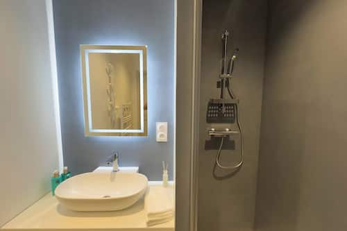 The Blue Duplex | Bathroom | Shower, hair dryer, towels, soap