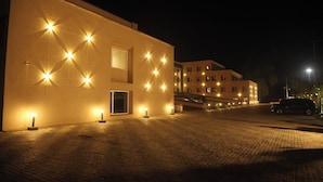 A building with multiple windows and a paved entrance area. - Rohika AAU-IGH (Guwahati)