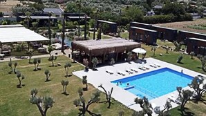 An aerial view of a resort with a swimming pool, covered outdoor seating, and multiple buildings. - Flu Alaçatı Tiny House Otel (Çesme)