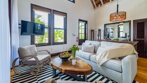 A modern living room with a sofa, armchair, and a coffee table.