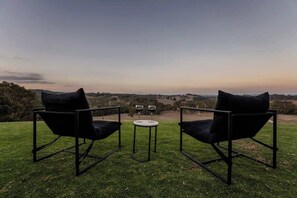 Two black chairs with cushions, a small round table, and a view of the landscape. - Farm Stay, Picturesque views (Balhannah)