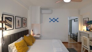 A modern bedroom with a bed, bedside table, and a ceiling fan. - Modern Living in Kolonaki (Athens)