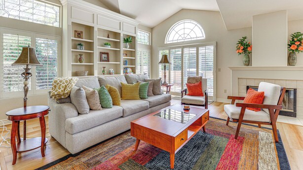 A spacious living room with a high ceiling, built-in shelving, a fireplace, and large windows. - Escondido Townhome w/ Gas Grill + Golf Acess! (Escondido)