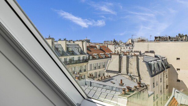 A view from a window overlooking a cityscape with multiple buildings, including a prominent dome structure. - Miel, 1BR/1BA, 3 people (París)