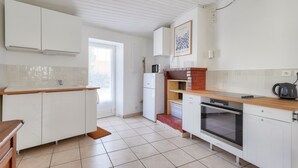 A modern kitchen with white cabinets, a built-in oven, a microwave, and a coffee maker. - Quiet location - 5min from La Terrière beach (La Tranche-sur-Mer)