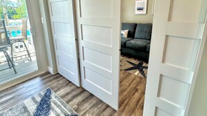 A room with a sliding door leading to a balcony, a grey sofa, and a star-patterned rug. - Updated Condo at The Lookout in Ogunquit (Ogunquit)