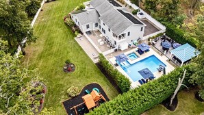 A large house with a swimming pool, a patio, and a small play area. - 6,000 Sq.ft. 18 Guests, 7-Bed, 6-Bath, Pool, Spa, Outdoor Kitchen, Garden, WIFI. (Middle Township)